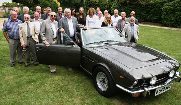 The cast & crew of The Living Daylights with the Aston Martin Volante convertible
